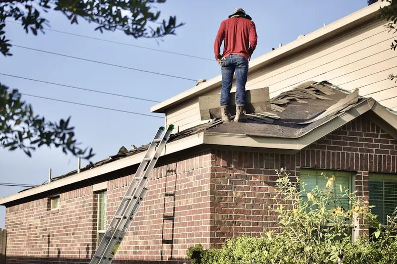 Professional roofer working on a residential roof in Rhoadesville